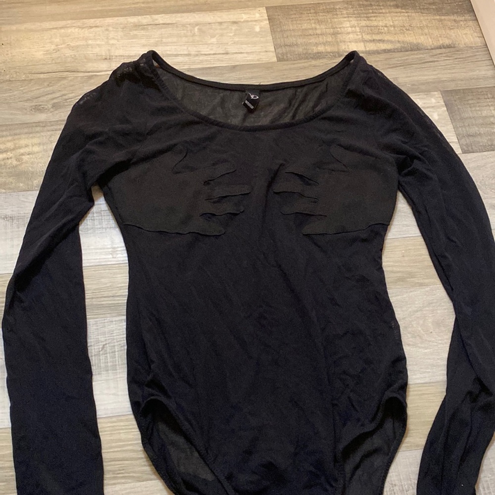 One piece, worn for costume. Has hands over the chest area